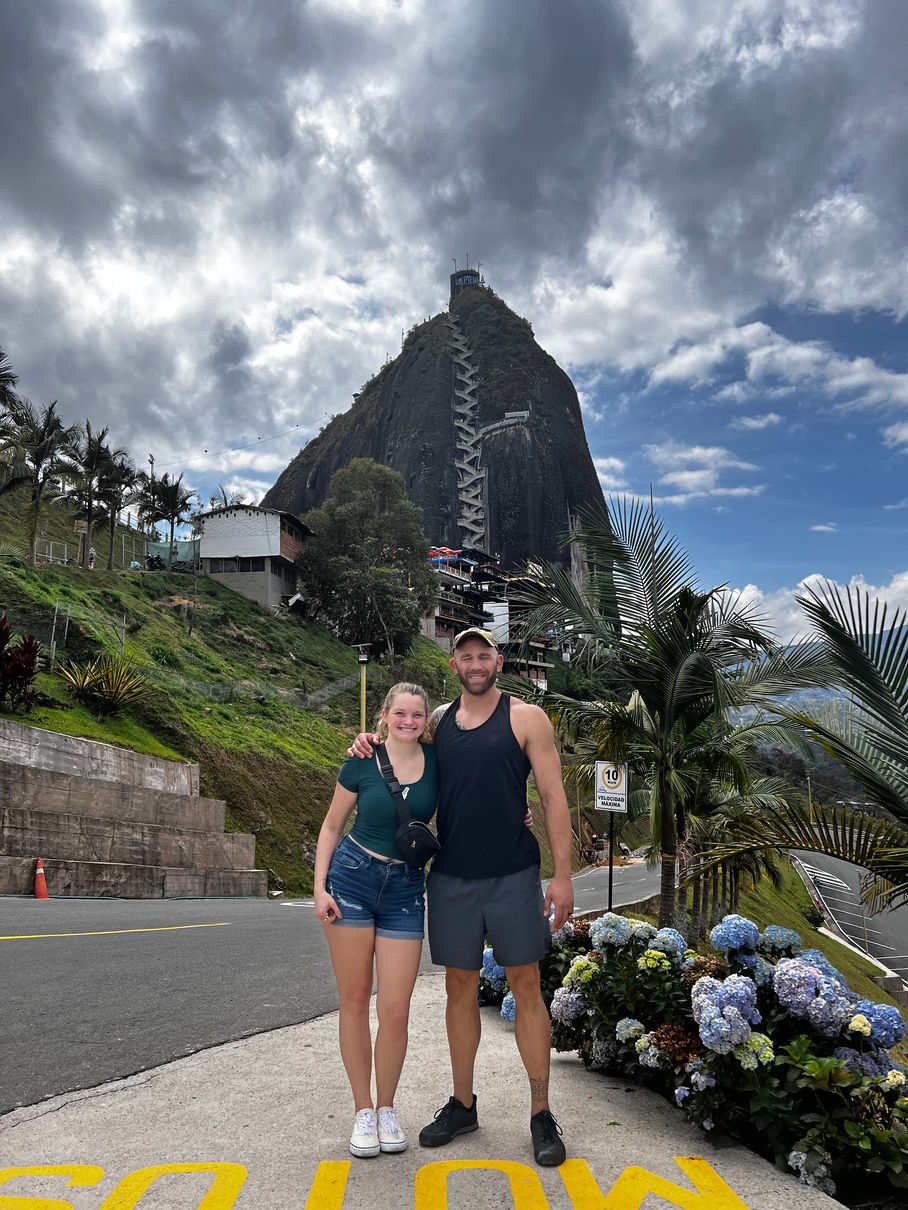 Lauren and her husband in front of El Peñón de Guatapé in Colombia